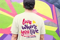 Love Where You Live tshirt on the back of man in front of art wall