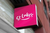 st luke's pink branded logo on sign outside building